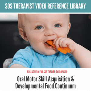 Baby in blue shirt chews on a carrot stick, promoting oral motor skill development.