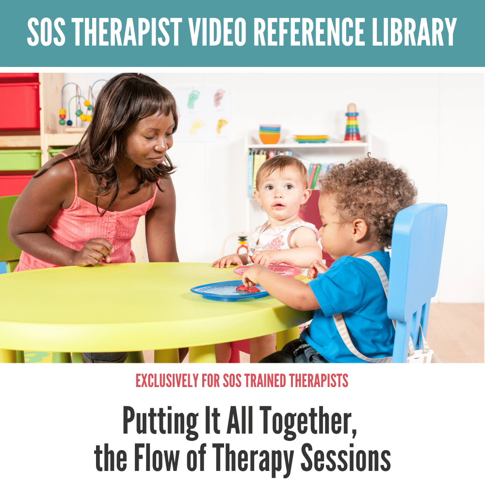Therapist engaging with two toddlers at a colorful play table, promoting healthy eating habits.